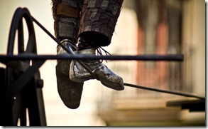 The feet of a tightrope walker.